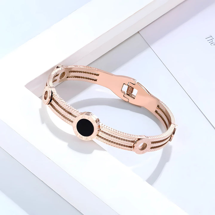Rose gold bangle bracelet with black stone, minimalist design, textured bands, elegant everyday jewelry