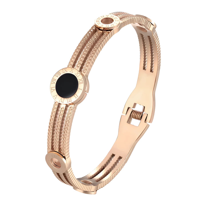 Rose gold bangle bracelet with Roman numeral accents and black enamel detail, minimalist luxury style