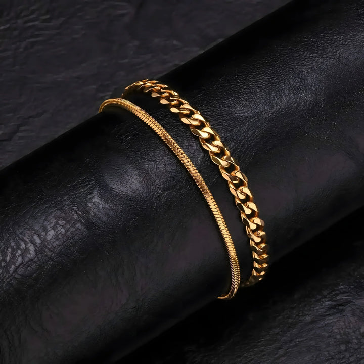 Gold chain bracelets: sleek snake chain and bold curb link, minimalist style on black leather