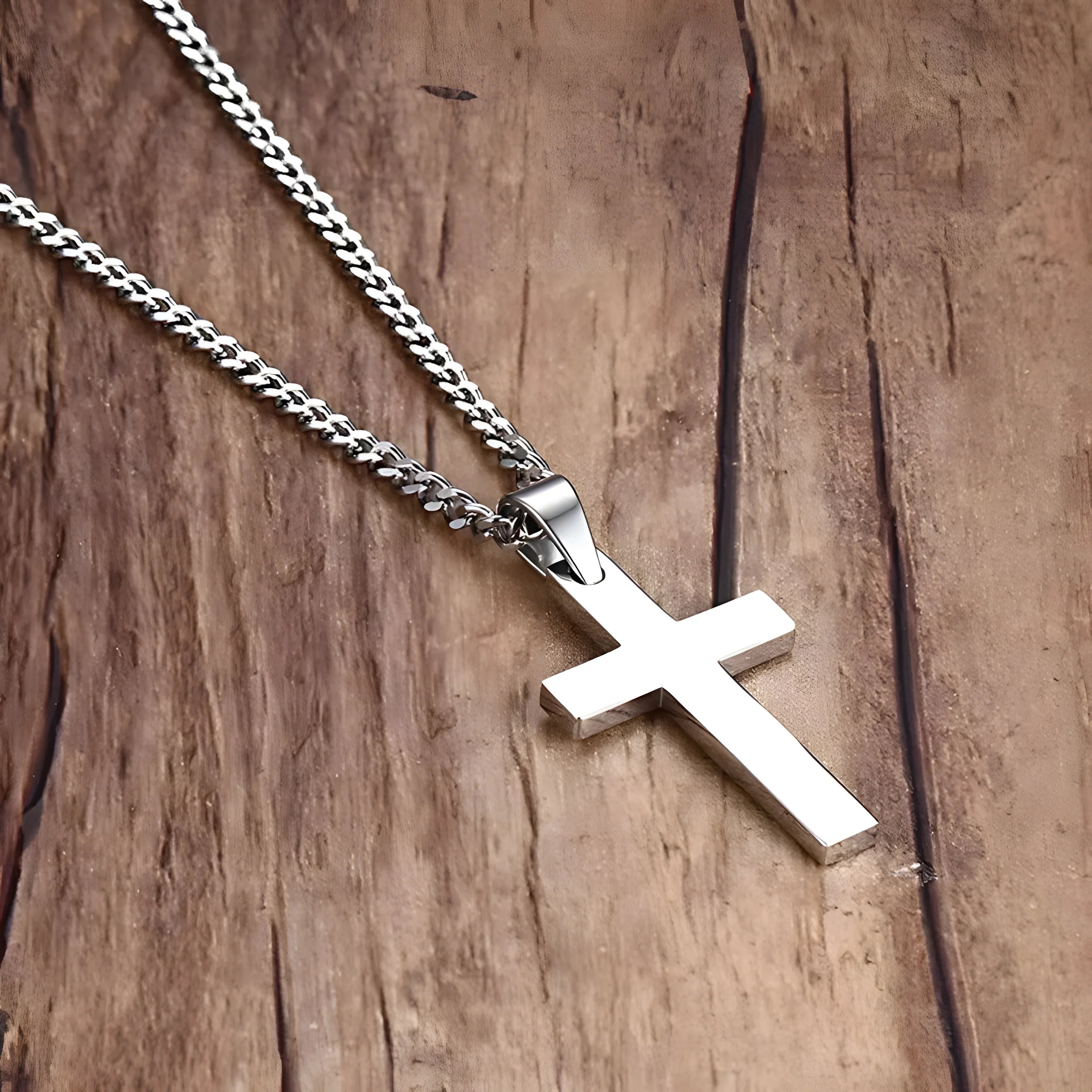 Titan Cross Necklace silver stainless steel minimal cross pendant chain on wood background