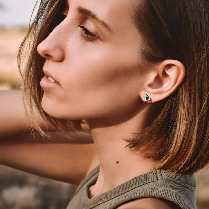 Minimalist triangle stud earrings in silver with black stone, modern everyday jewelry style