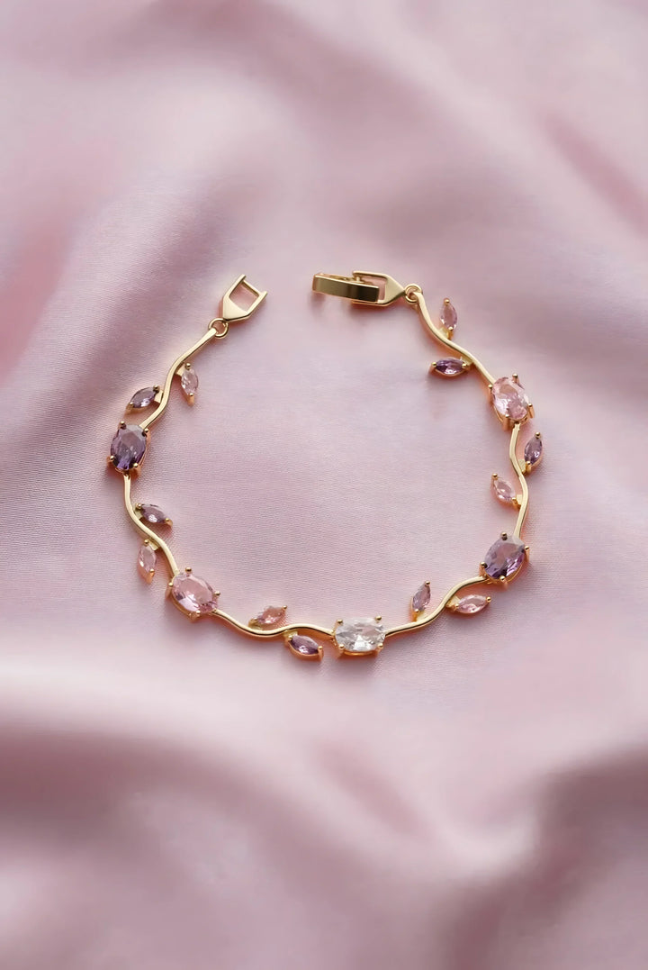 Gold bracelet with pink and purple gemstones, minimal vine design, elegant everyday jewelry