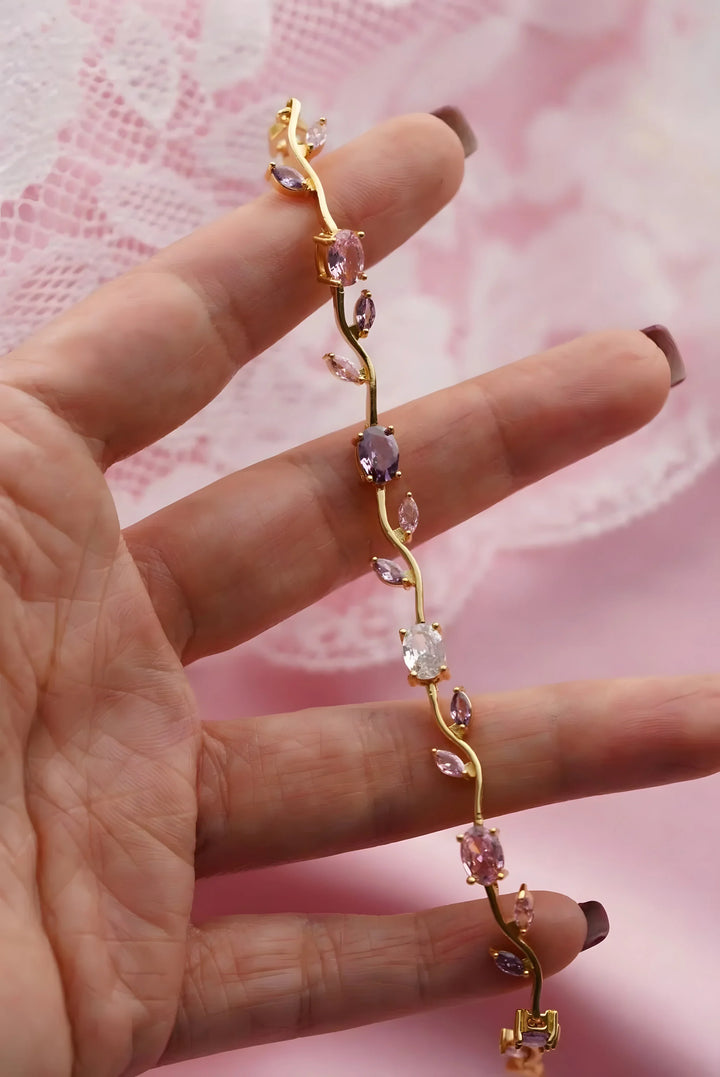 Gold vine bracelet with pink and purple gemstones, elegant minimal style