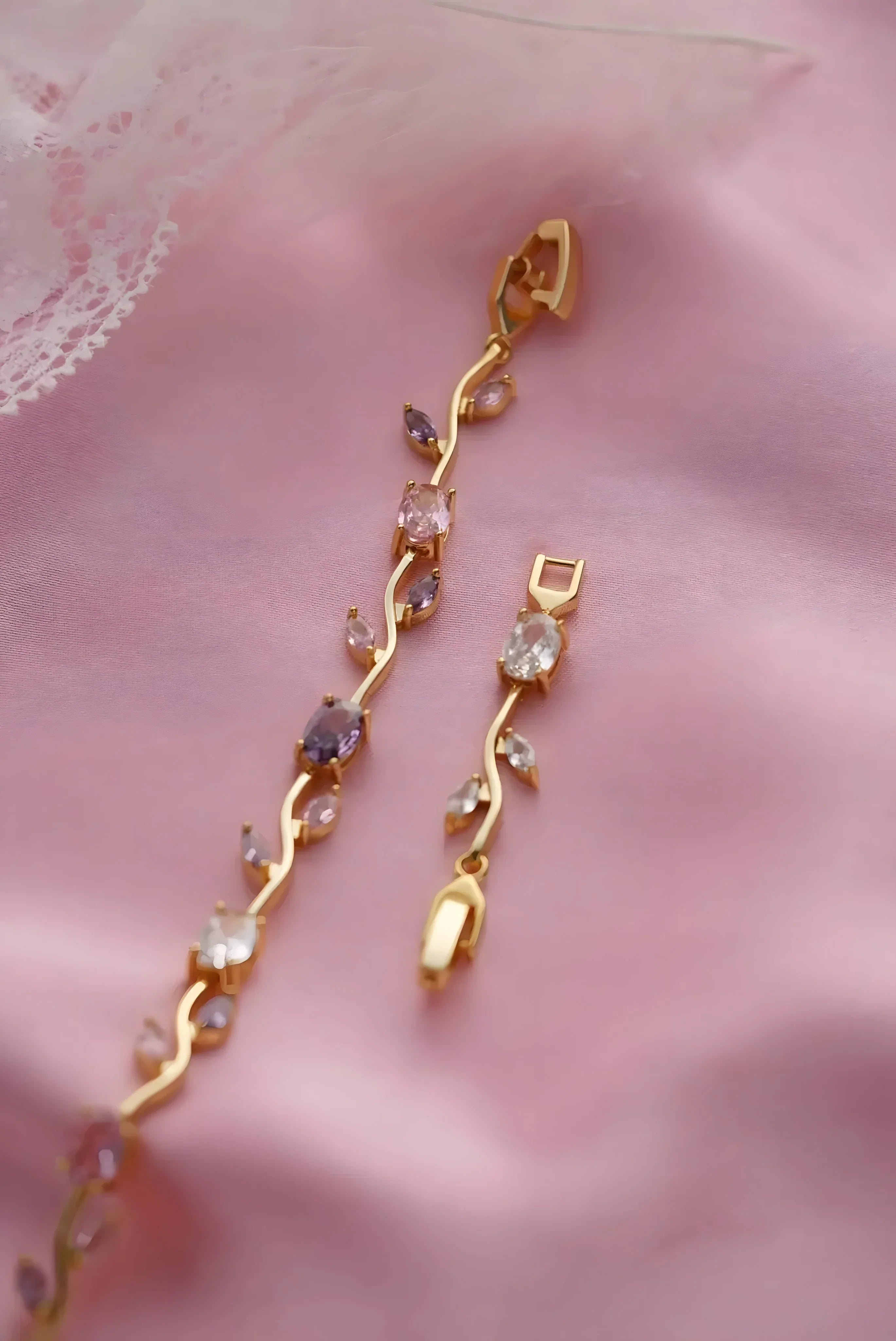 Gold vine-style bracelet with pink and clear gemstones, elegant minimal design