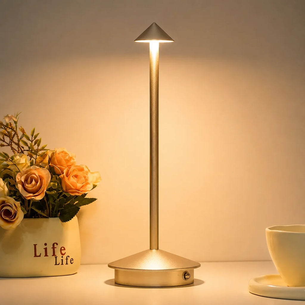 Modern gold table lamp with cone-shaped shade for bedroom or desk lighting