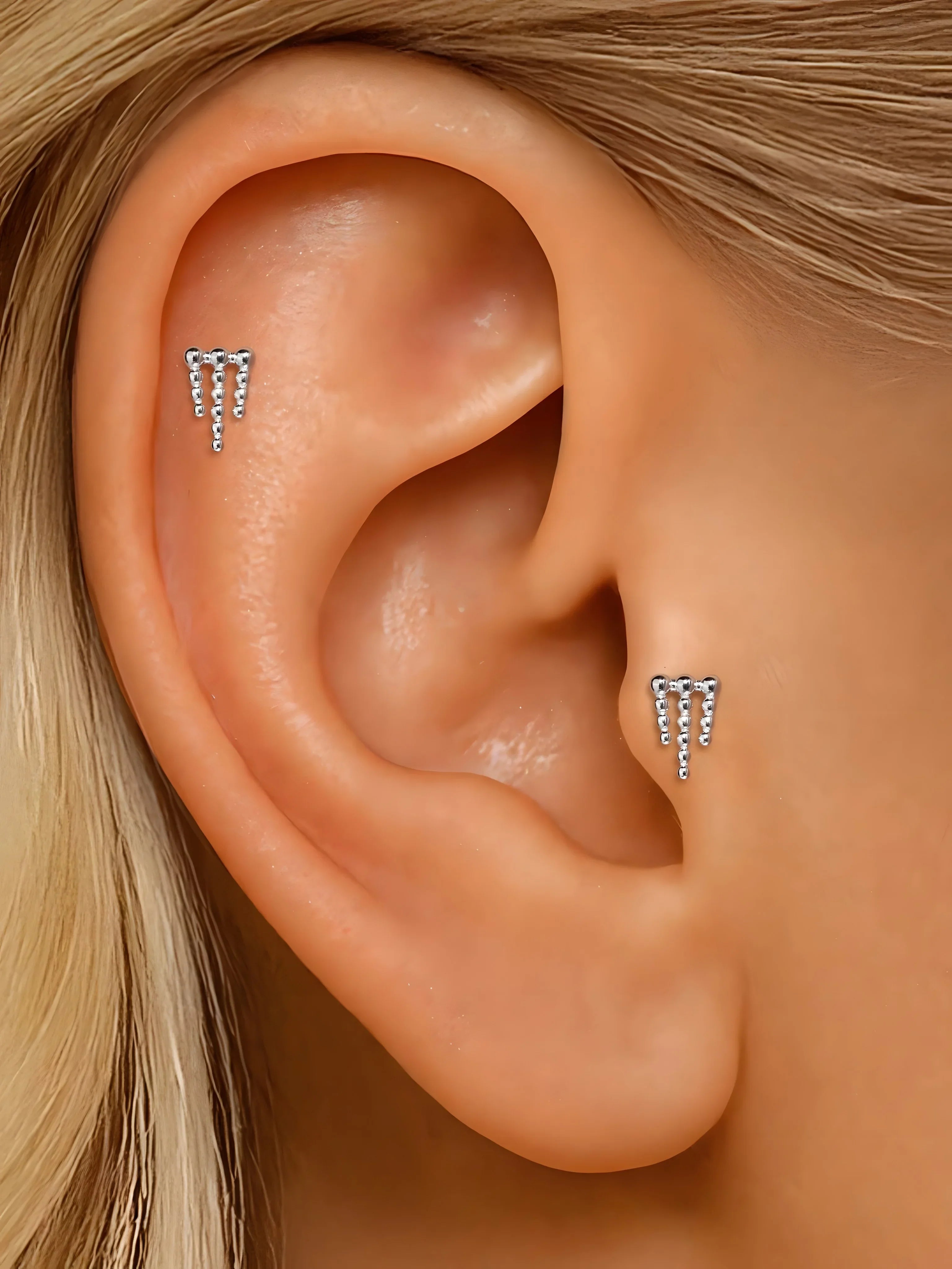 Zircon stud earrings, silver tone, minimalist dangle style, worn on ear, modern jewelry